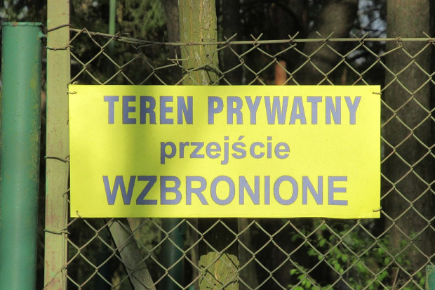 Tablica - jedna z wielu podobnych - na ogrodzeniu przy jeziorze Białym (Okuninka, woj. lubelskie; fot. Grzegorz W. Tężycki, CC BY-SA 4.0, wikimedia)